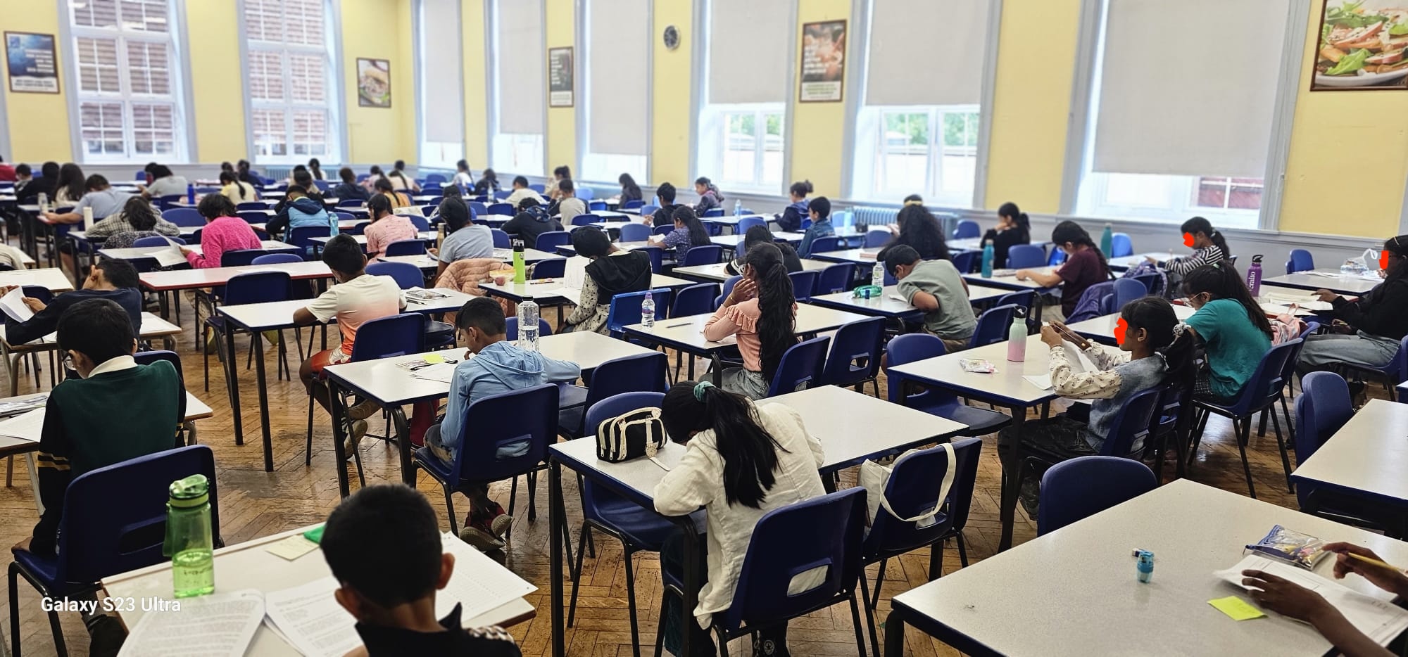 Children writing during a GLECTA 11+ mock test, photographed from behind